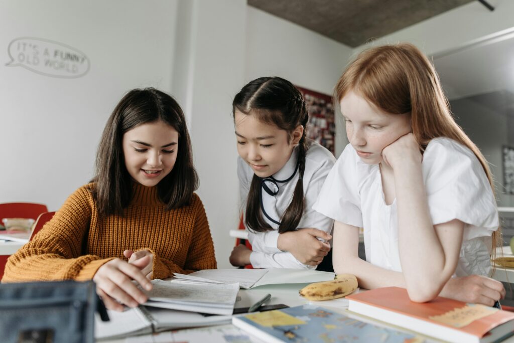 Teacher with two students focusing on their lesson